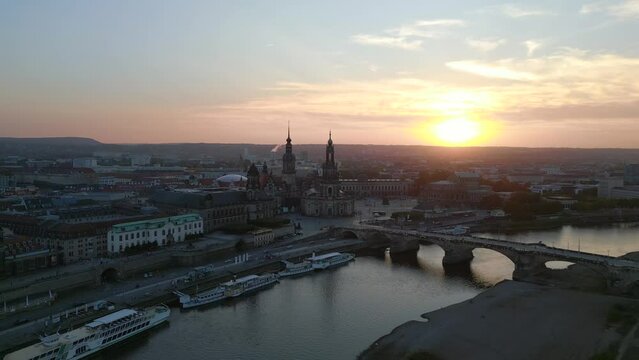 Amazing aerial top view flight drone. Sunset town Dresden Cathedral Bridge River
