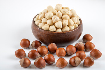 Group of peeled and shelled hazelnuts on white background