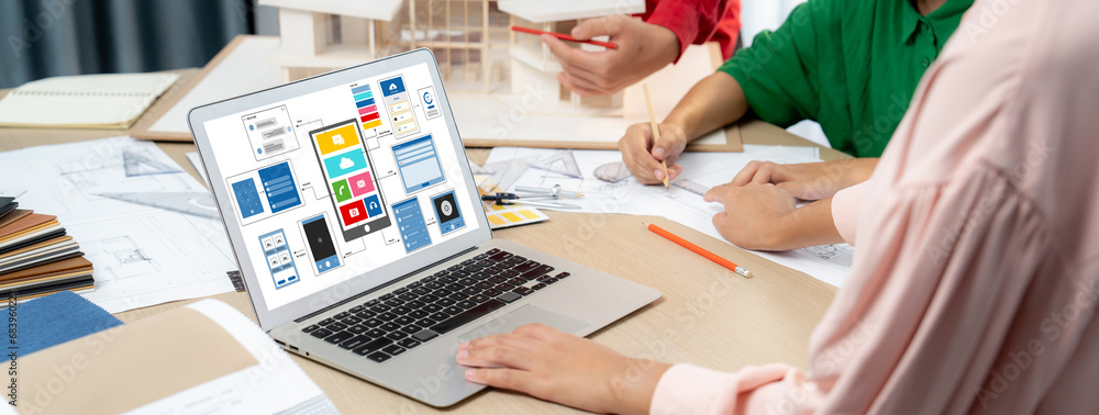 Poster cropped image of interior designer team presents color by using color swatches while laptop displaye
