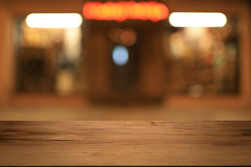 Beautiful empty wood table top counter, window view. Wooden table with blur bokeh background ready...