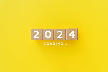 2024 New Year Loading. Loading bar with wooden blocks 2024 on yellow background. Start new year 2024 with goal plan, goal concept, action plan, strategy, new year business vision. Horizontal backgroun