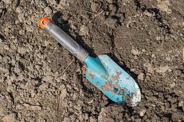 garden shovel on brown earth