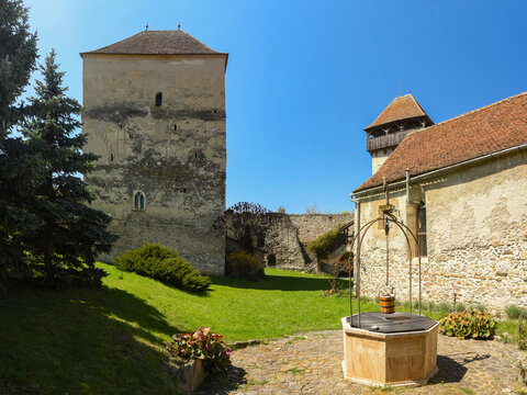 Interior panorama of Calnic medieval fortress. The old defensive bastion, with stone walls surrounding the church, was built in a rural area of Transylvania. A stone well can be seen in the interior
