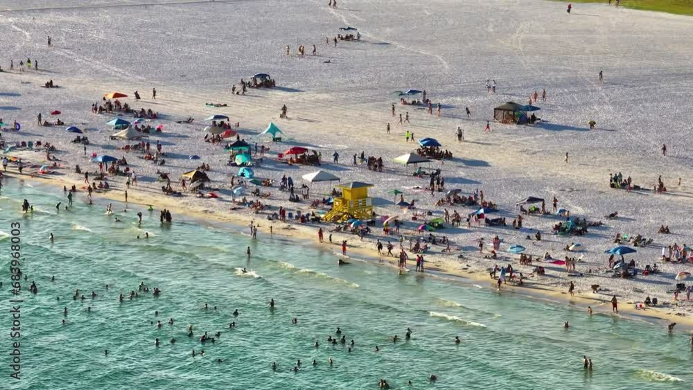 Canvas Prints View from above of evening Siesta Key beach with white sands full of tourists in Sarasota, USA. Many people enjoing vacation time swimming in Mexica gulf water and relaxing on warm Florida sun