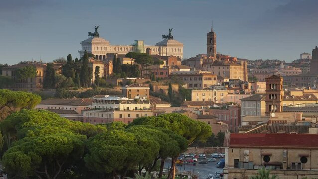 Panning shot of morning Rome, Italy. Sunrise view from Terrazza Belvedere Aventino in Rome. Altare della Patria, old houses and churches
