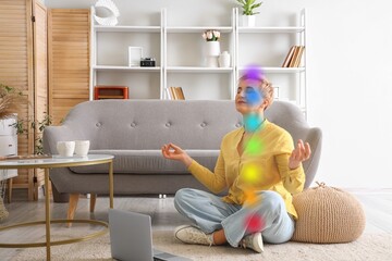 Mature woman with laptop meditating at home