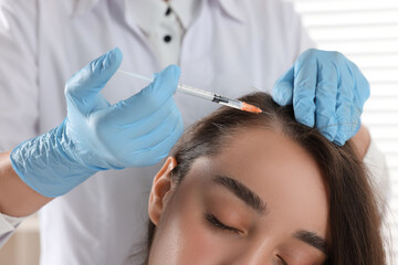 Trichologist giving injection to patient, closeup view
