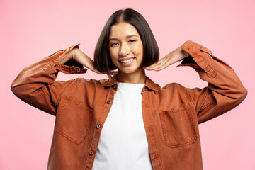 Portrait of beautiful young Asian hipster woman with stylish bob hairstyle wearing brown shirt