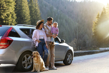 Parents, their daughter and dog near car outdoors, space for text. Family traveling with pet