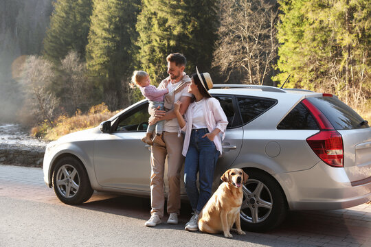 Parents, Their Daughter And Dog Near Car Outdoors. Family Traveling With Pet