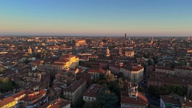 Aerial morning shot of Bologna, Italy. Flying above red tiled roofs of the old town in Bologna