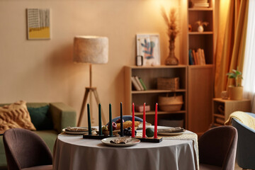 Red, Black and green candles in the center of dinner table served for family Kwanzaa celebration