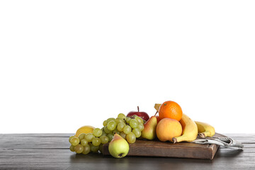 Board with fresh fruits on black wooden kitchen table against white background