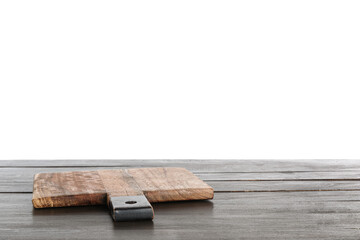 Cutting board on black wooden kitchen table against white background