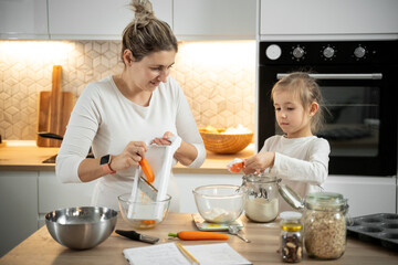 mom and daughter baking carrot cake home learning cooking ingredients 