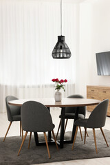Stylish dining room interior with table and chairs