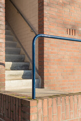 an entrance to a brick building with stairs and railing