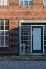 brick wall with windows and entrance door