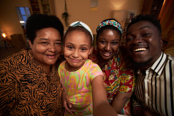 Happy little girl taking selfie with smile family at home - obrazy, fototapety, plakaty