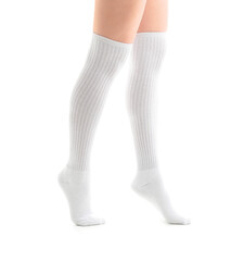 Legs of young woman in knee socks on white background