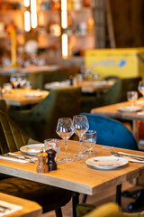 Wooden square table in a cafe for two with plates and empty glasses