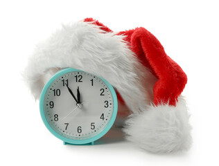 Alarm clock with Santa hat on white background