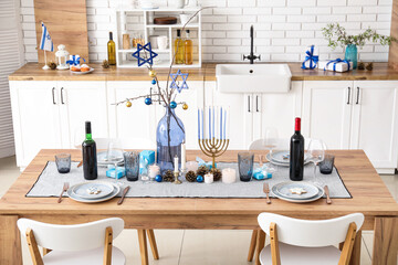 Festive table setting with Hanukkah decorations in kitchen