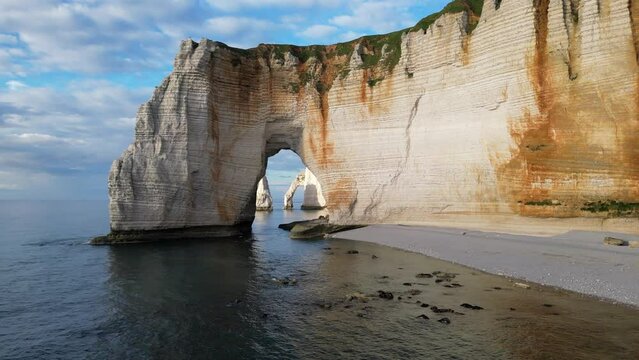 Aerial 4k drone view of Etretat. L'Aiguille, The Needle, Famous Alabaster chalk seacoast, Porte Aval cliffs, Natural Rock Arch Of &Eacute;tretat, Normandy, France, Atlantic Ocean, French holidays, landscape