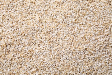 Raw barley groats as background, top view