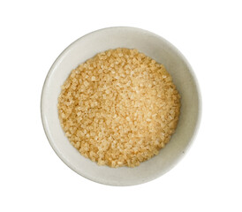 Small bowl of raw brown sugar isolated on white