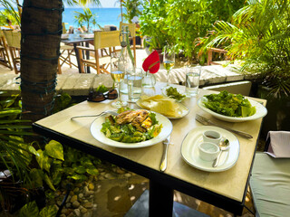 View of a lunch on a terrace by Seven Mile Beach in the Caribbean, Grand Cayman - 683990203