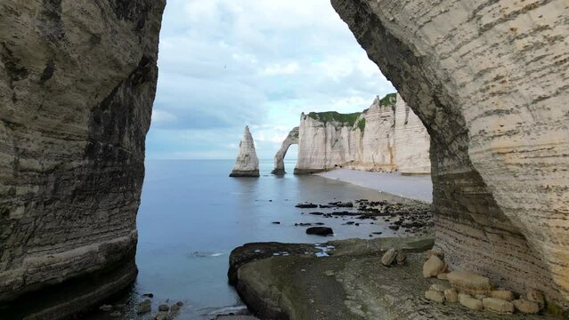 Aerial 4k drone view of Etretat. L'Aiguille, The Needle, Famous Alabaster chalk seacoast, Porte Aval cliffs, Natural Rock Arch Of &Eacute;tretat, Normandy, France, Atlantic Ocean, French holidays, landscape