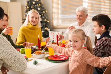 Little girl having family dinner at home on Christmas eve