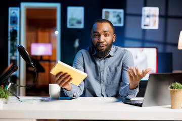 Internet show host being sponsored by partnering publisher to do new book unboxing content. Literature critic does influencer marketing, doing new author novel product placement