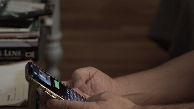 Close-up of a man using his smartphone to text.