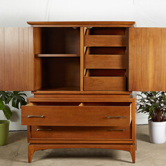 Vintage warm walnut dresser with teardrop pulls. Mid-century modern furniture. Interior photograph...