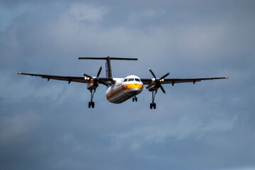 A Tiny Airborne Wonder: A Small Airplane Soaring Through the Majestic Cloudscape