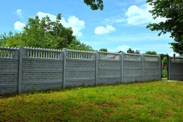 Fence made of decorative concrete fencing spans - obrazy, fototapety, plakaty