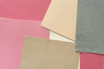 paper background (in pink, red, beige, brown, and gray with varying degrees of surface texture)