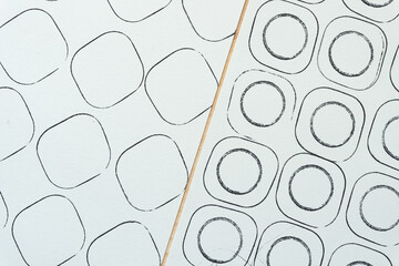 two sorts of abstract sketchbook paper with black ink circles in rounded corner squares arranged...