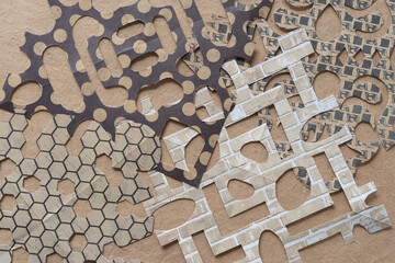 an abstraction of decorative paper designs mimicking the delicate patterns of snowflakes on brown...