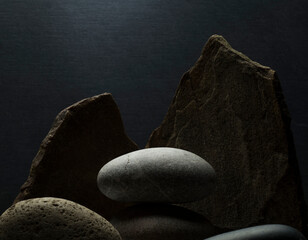 composition of stones on a dark background for the podium. minimalistic still life with natural stones for product presentation, background.