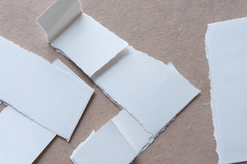 paper stripes with torn edges folded into one another and arranged as arrows or chevrons on plain...