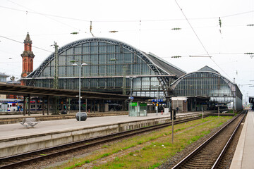 Scenic view of the bustling platforms at Bremen Central Railway Station, featuring passengers waiting for their trains amidst the architectural beauty and modern infrastructure of the station.
