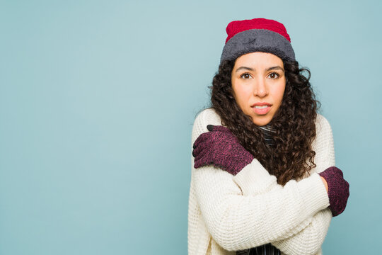 Beautiful woman with winter clothes feeling cold