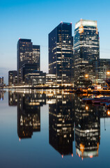 Reflections of corporate buildings in water, Canary Wharf, London