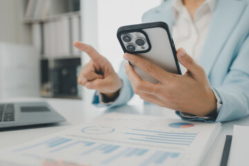 An entrepreneur is talking on the phone with a company customer, Businesswoman is sitting and working in the office, Recording various information on paper,