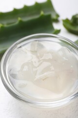 Aloe vera gel in bowl on white background, closeup