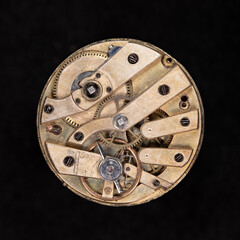 Color high resolution metal wheels and cogs inside movement of old watch, pocket watch. Macro...