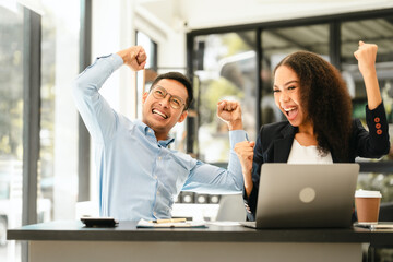 Asian business man and African American woman engaging in business discussion, possibly about merger or joint venture. two companies become one, one of companies often survives while other disappears